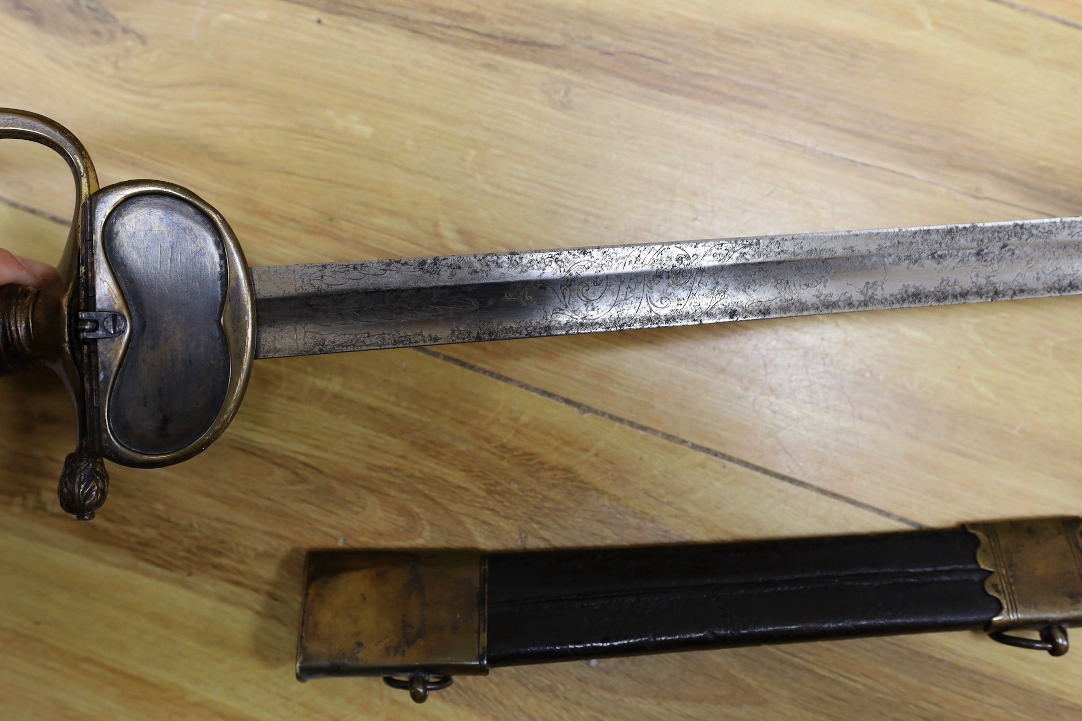 An 18th century European brass hilted sword and scabbard. 89cm long